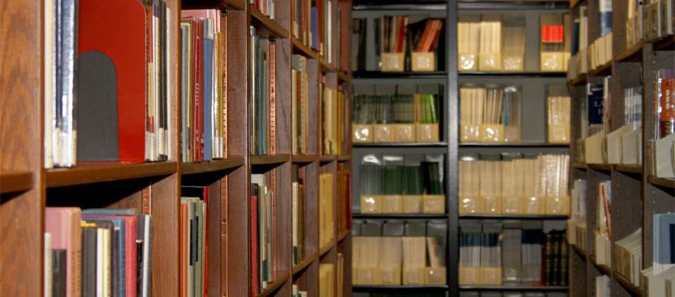 A bookshelf full of books and articles which are available in the BOP library in Washington, DC